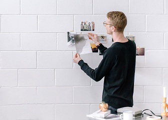 Designer pinning references on a wall